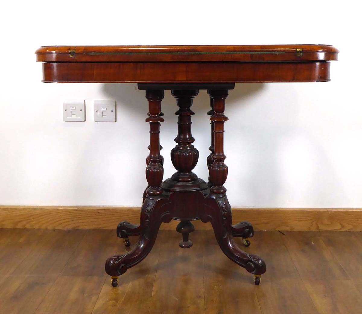 A Victorian figured walnut and marquetry games table on four turned columns and splayed legs with - Image 2 of 5