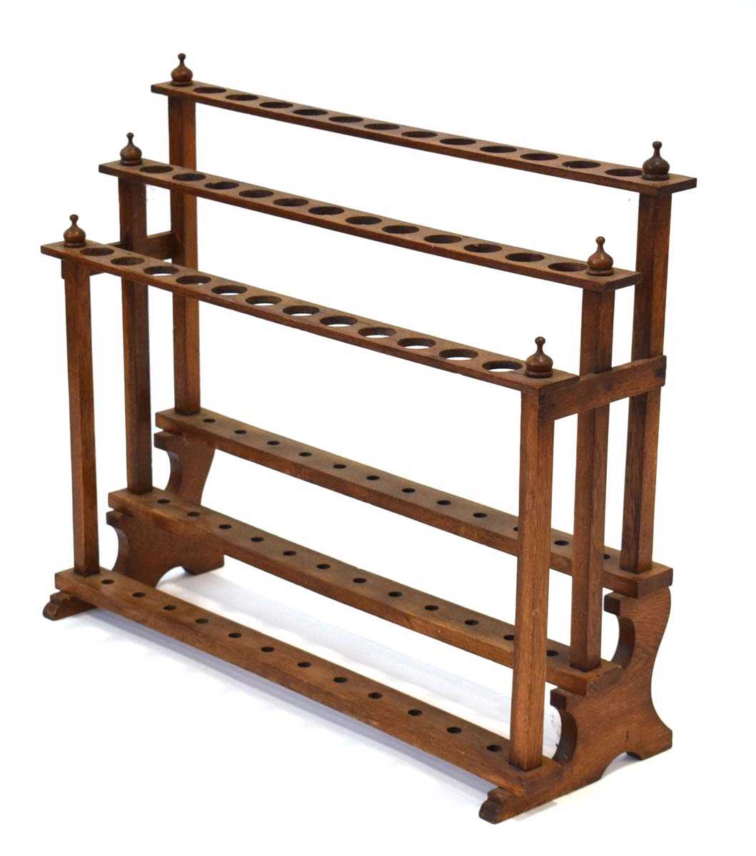 An early 20th century oak three-tier stick stand, w. 74 cm, h. 60 cm