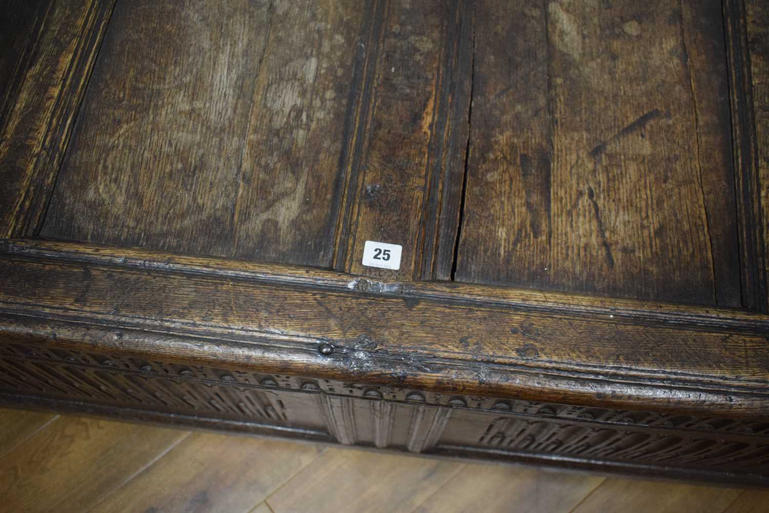 An 18th century oak coffer of long proportions, the four-panelled surface over two later carved - Image 3 of 16