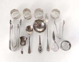 A mixed group of silver comprising five napkin rings, a sifting spoon, a tea scuttle, a