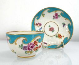 A Chelsea tea bowl and saucer dish decorated with floral sprays on a turquoise ground, saucer d.