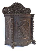 A 19th century Anglo-Indian (?)padouk side cabinet, the intricately carved back over a bow-front and