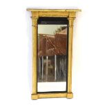 A 19th century giltwood wall mirror in the French style, the rectangular plate flanked by a pair