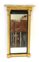 A 19th century giltwood wall mirror in the French style, the rectangular plate flanked by a pair