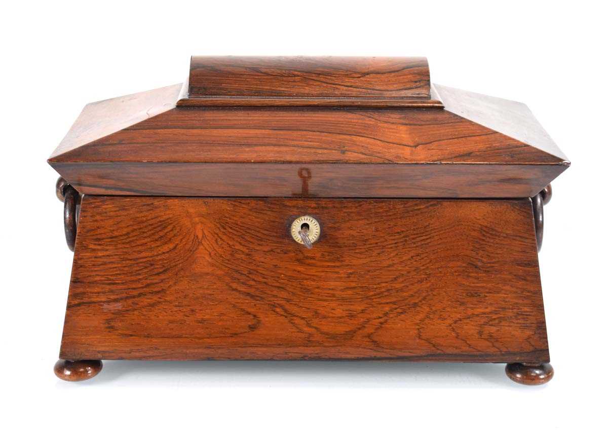 A mid-19th century rosewood tea caddy of sarcophagus form, the interior with two detachable