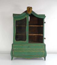 A miniature apprentice piece modelled as a Dutch bombe bookcase-cabinet, painted in green, h. 59
