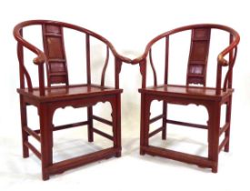 A pair of Chinese red painted Ming-style armchairs of cow horn form, w. 67 cm, h. 101 cm, d. 61