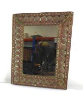 A late 19th/early 20th century copper-finished mirror, the rectangular plate within shell borders,