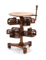 A Victorian mahogany and fretwork revolving library table bookcase, the circular surface with an