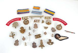 A group of military badges, patches, medal ribbons etc. including four silver ARP badges, a silver