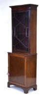 An early 20th century mahogany bookcase-cabinet, the glazed door enclosing adjustable shelves over a