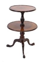 A George III mahogany two-tier dumb waiter on baluster supports and a tripod base, h. 86 cm