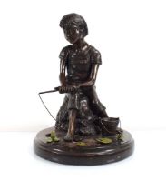 A 20th century bronze and green patinated group by Adolf Sehring modelled as a boy fishing with