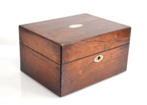 A Victorian rosewood and ivory mounted dressing table box containing a fitted interior with