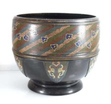 A late 19th century champlevé jardinière decorated with coloured bands over geometric panels, di. 28