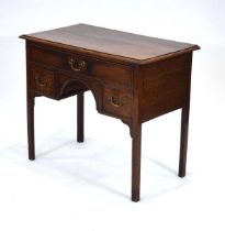 A George III and later oak lowboy, the top drawer converted to hold a concealed section, over two