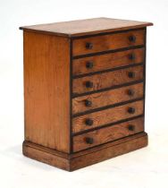 A pine six-drawer collector's cabinet on a plinth base, 38 x 22 x 41 cm