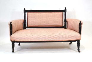 An Aesthetic Movement sofa, the ebonised and gilt highlighted frame with geometric salmon