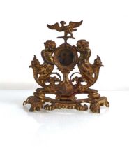 A brass pocket watch holder decorated with cherubs and an eagle, h. 22 cm