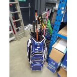 Blue and white Mizuno golf bag with assorted clubs