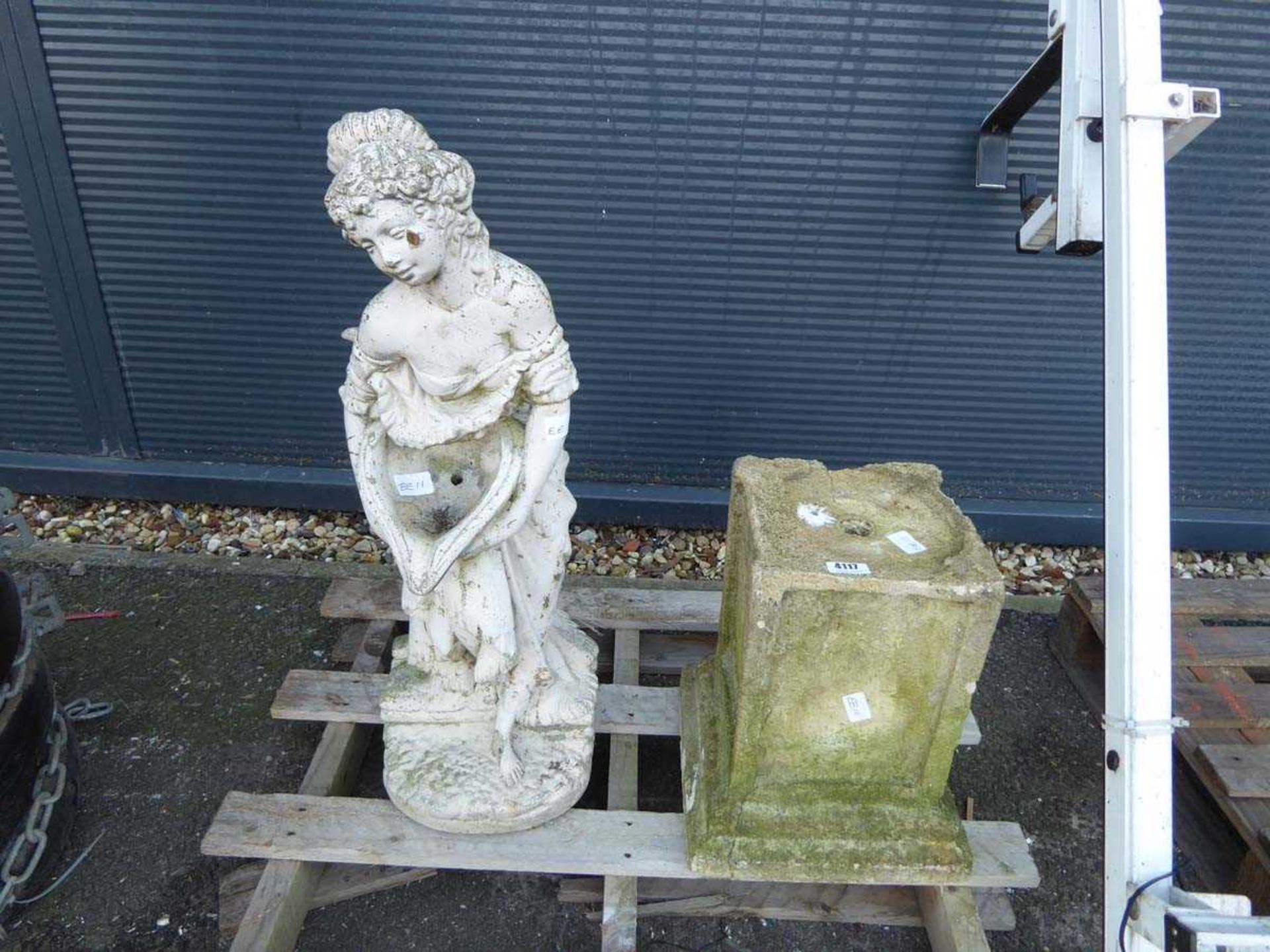 Concrete statue of a lady and a plinth