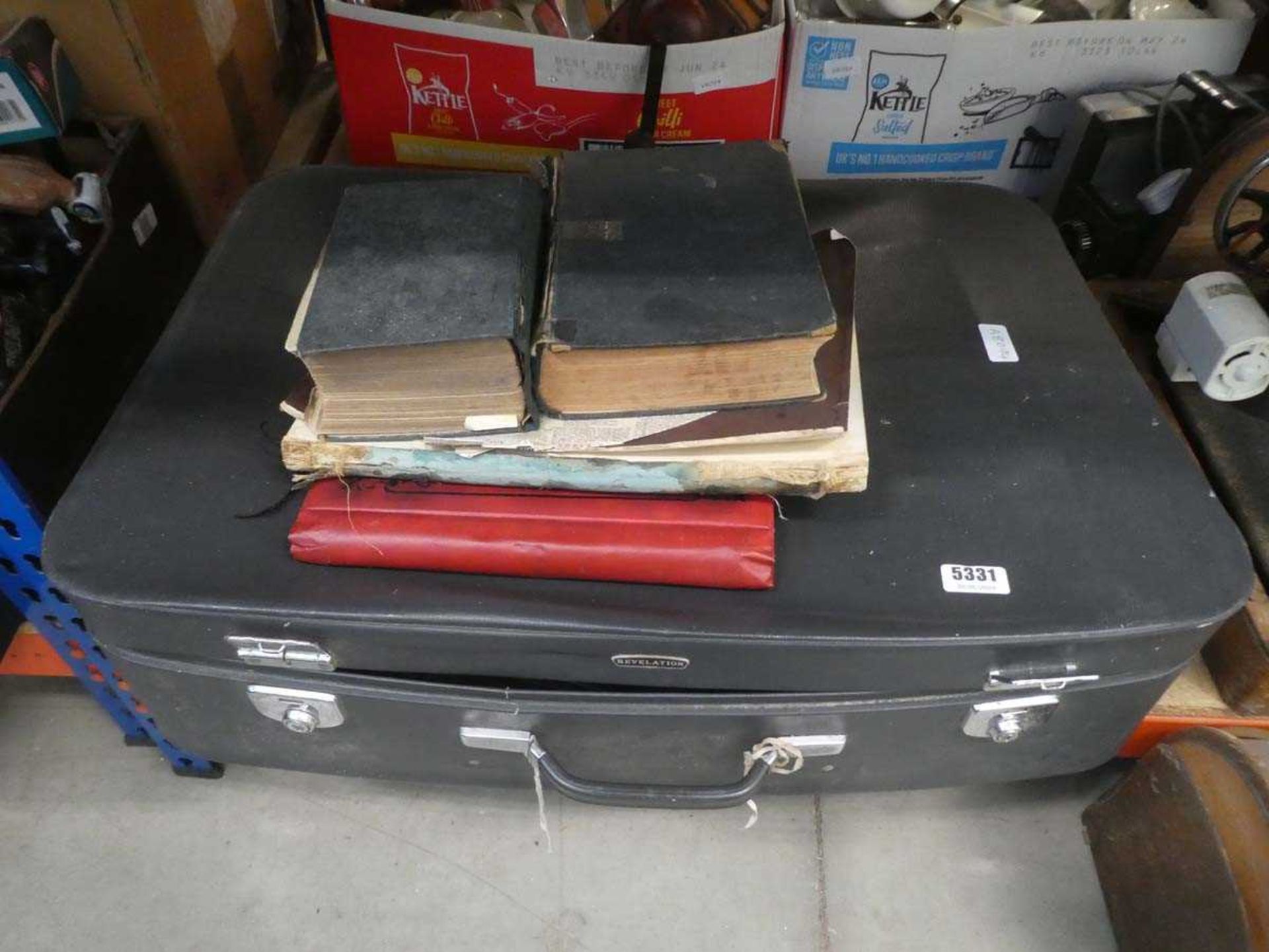 Suitcase containing reference books and novels