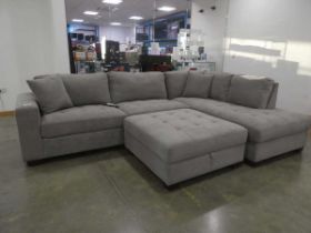 +VAT Grey fabric corner suite in 2 sections, plus a footstall General good condition. Approx.