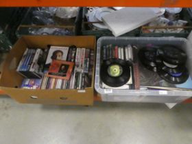 2 boxes containing DVDs, CDs, tape cassettes and vinyl records