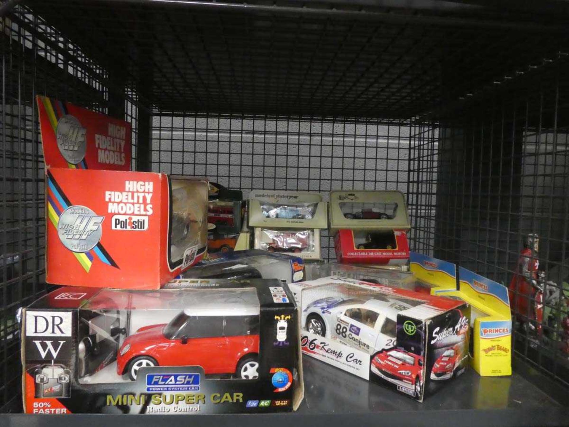 Cage containing boxed Models of Yesteryear and other die cast vehicles