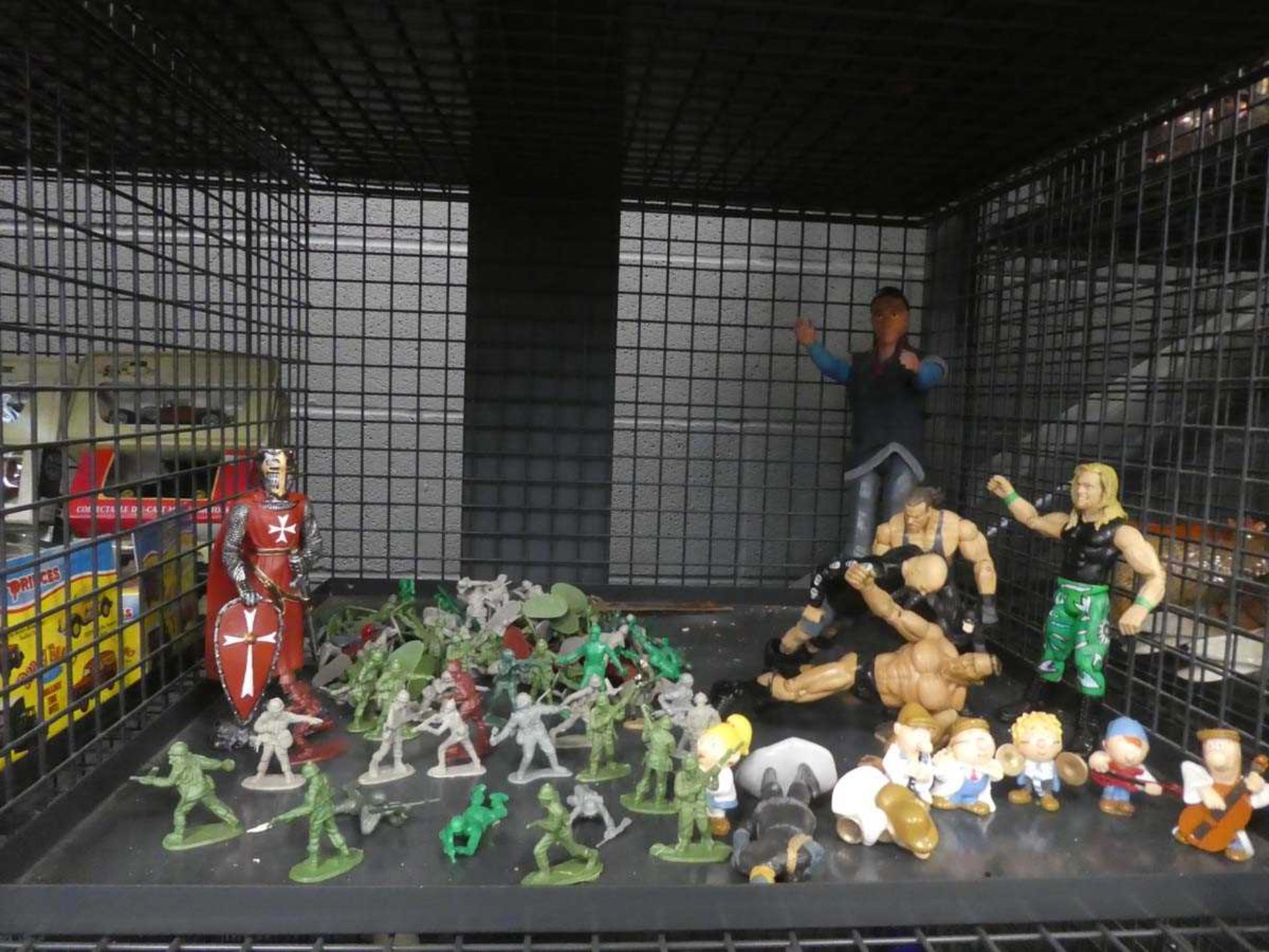Cage containing Action Man figures and plastic soldiers