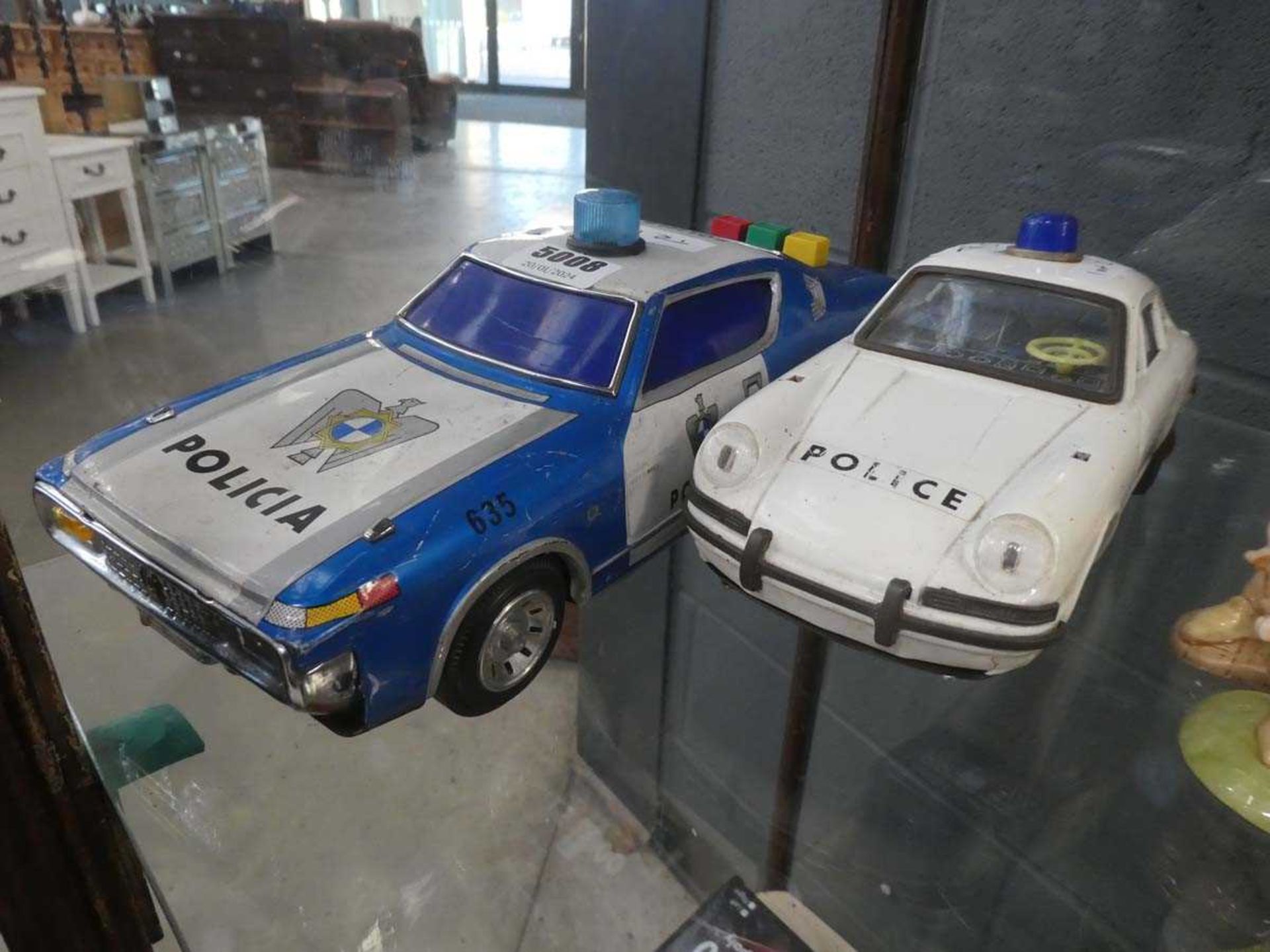Two tin plate police cars