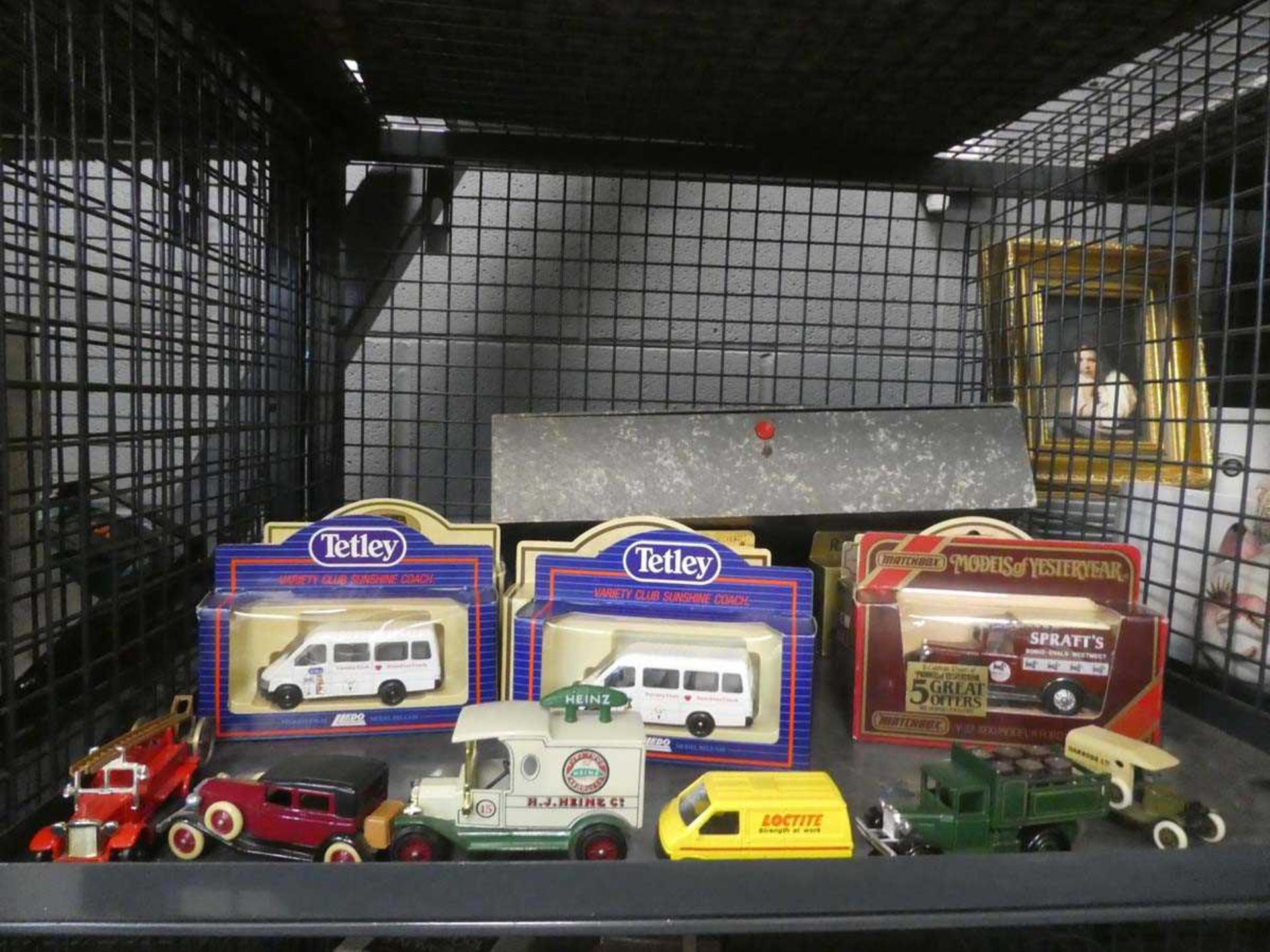 Cage containing Lledo and Models of Yesteryear die cast cars