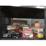 Cage containing various boxed and loose die cast vehicles