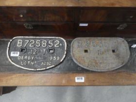 Two cast iron train signs