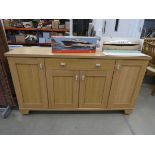 Oak finished sideboard with drawer and four doors under