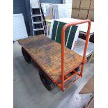 4 wheel orange wooden trolley