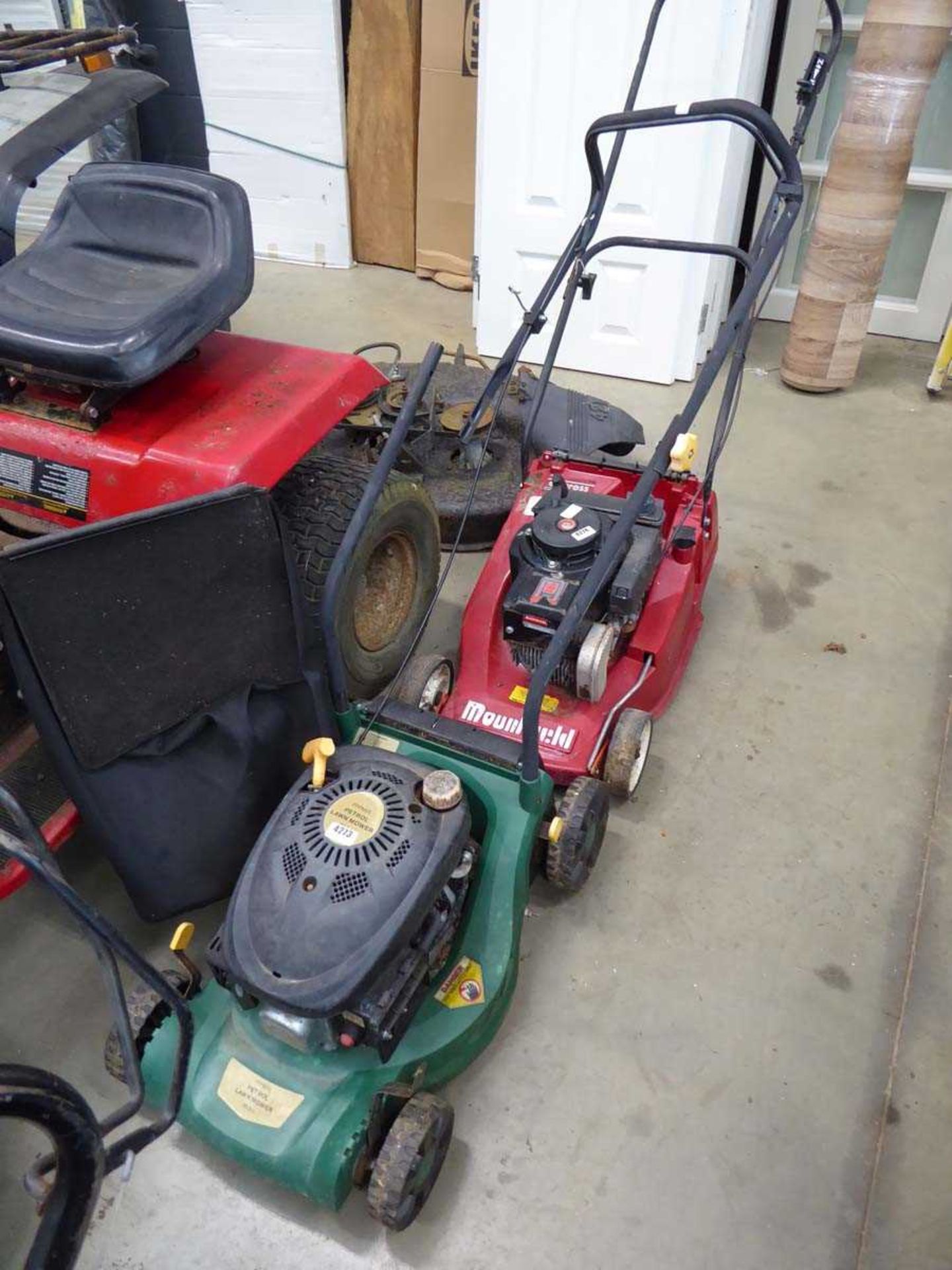 Green petrol powered rotary mower with grass box