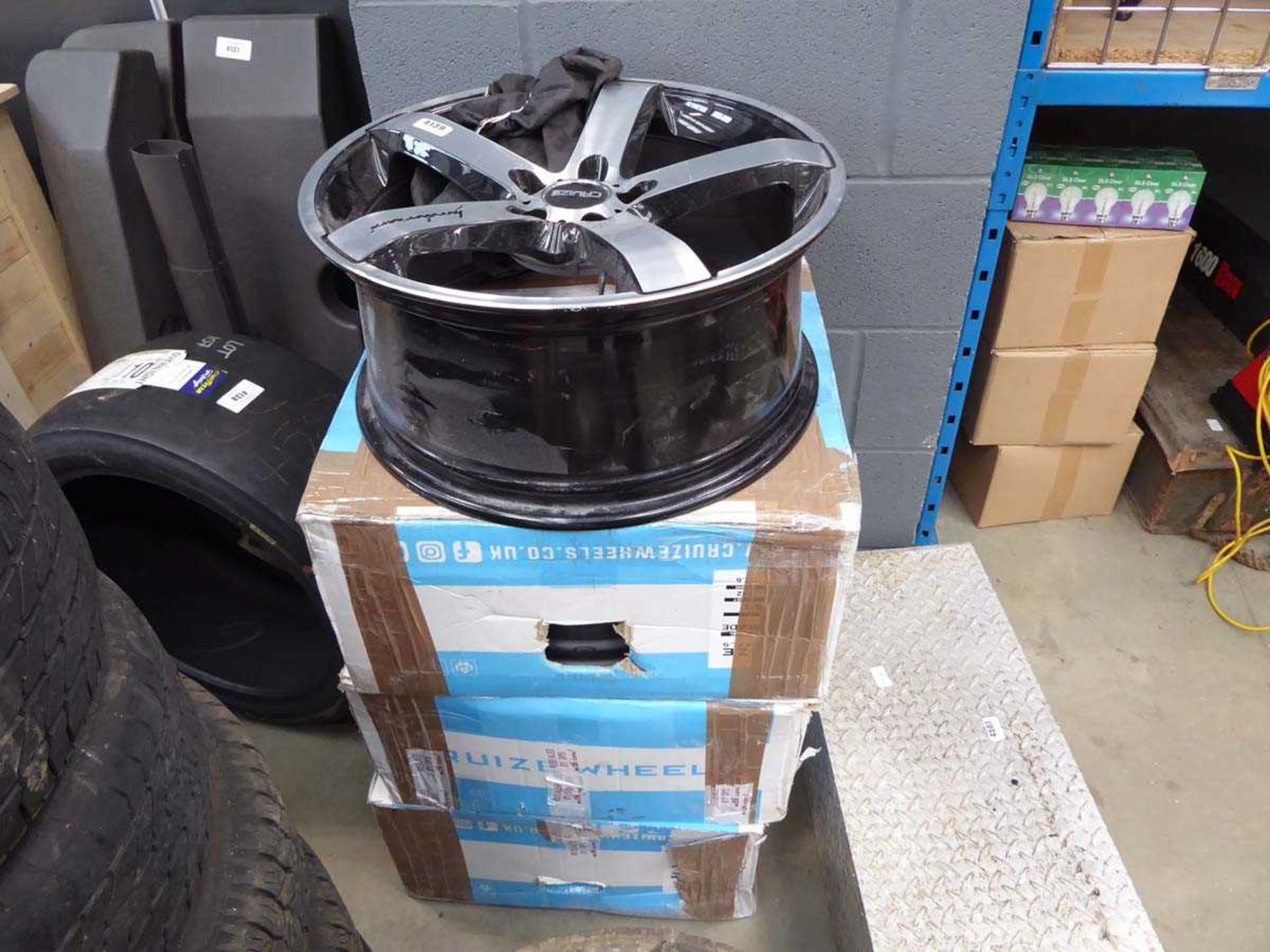 Three boxed and one unboxed Cruize alloy wheel