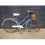 Blue and white lady's bike with front basket