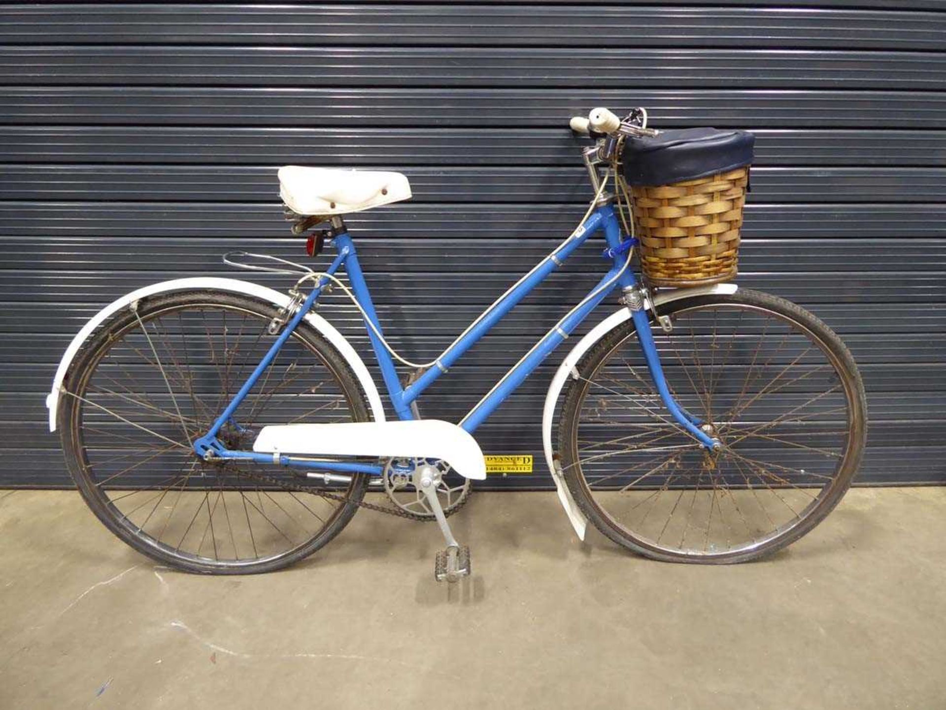 Blue and white lady's bike with front basket