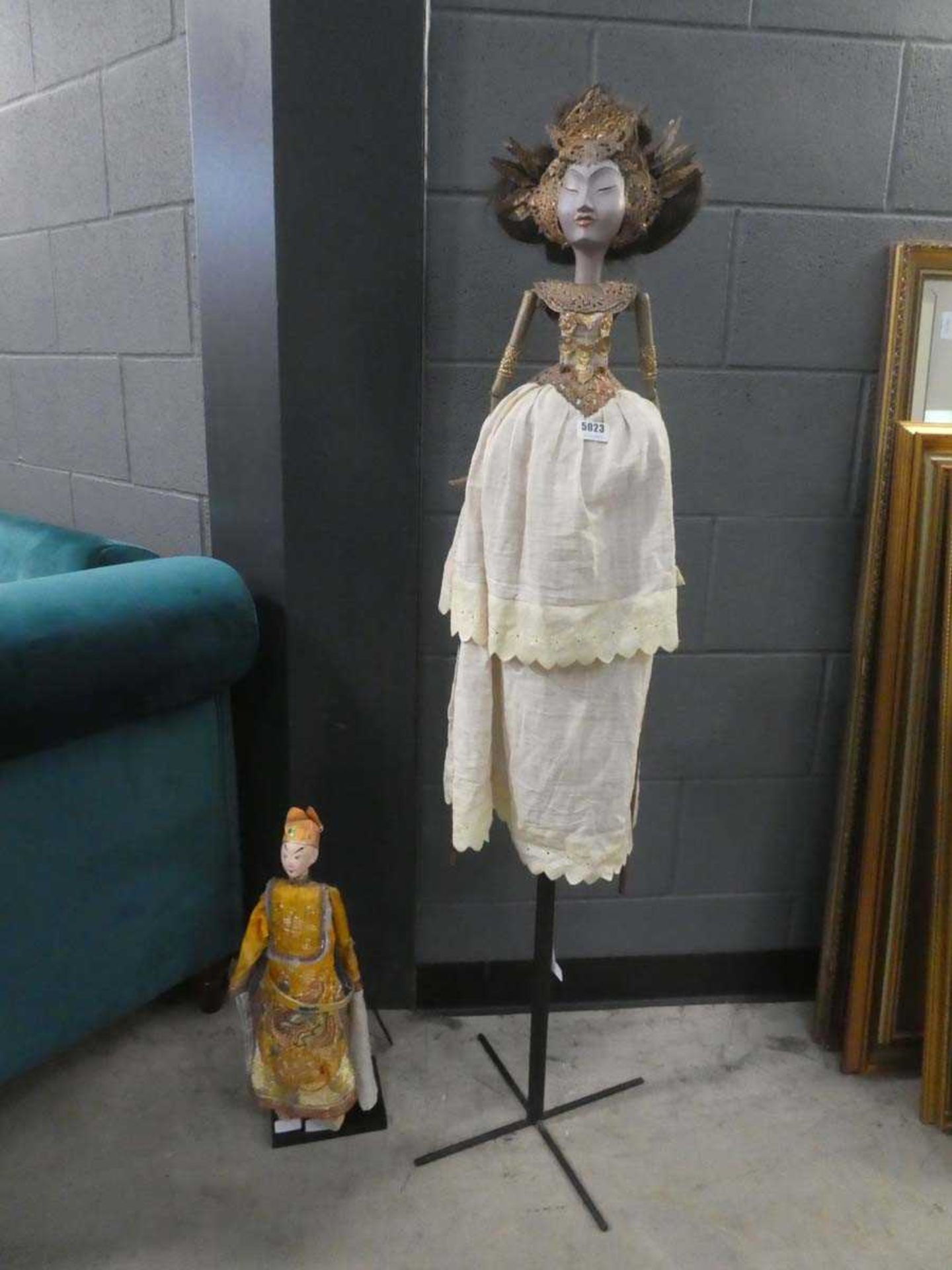 Two Balinese puppet figures on stands