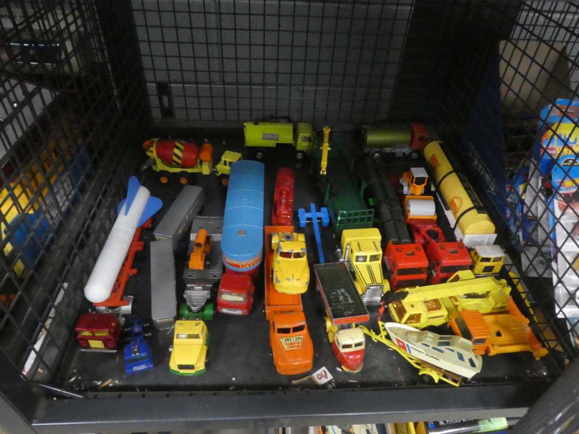 Cage containing playworn die cast vehicles