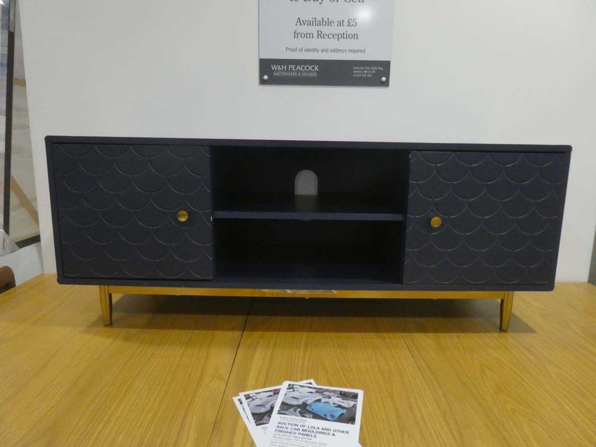 Modern entertainment unit with central drawers and cupboards to the side