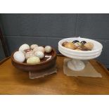 Two onyx and wooden fruit bowls with quantity of artificial stone and wooden eggs