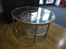 Modern brass finish nesting pair of circular glass top coffee tables