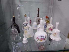 Shelf of various ceramic and glass collectible bells