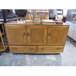 Mid century ash and elm Ercol sideboard with 3 doors and 2 lower drawers on castors in blonde