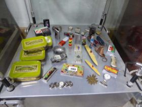 Shelf of various lighters, watches, tins and other similar collectibles