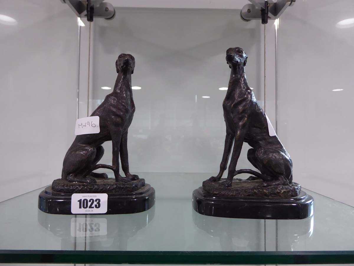 Pair of bronze finish seated greyhounds on marble plinths, bearing the signature, 'BARRIE'