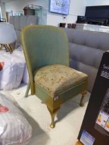 Green and gilt finish Lloyd Loom chair with floral upholstered cushion
